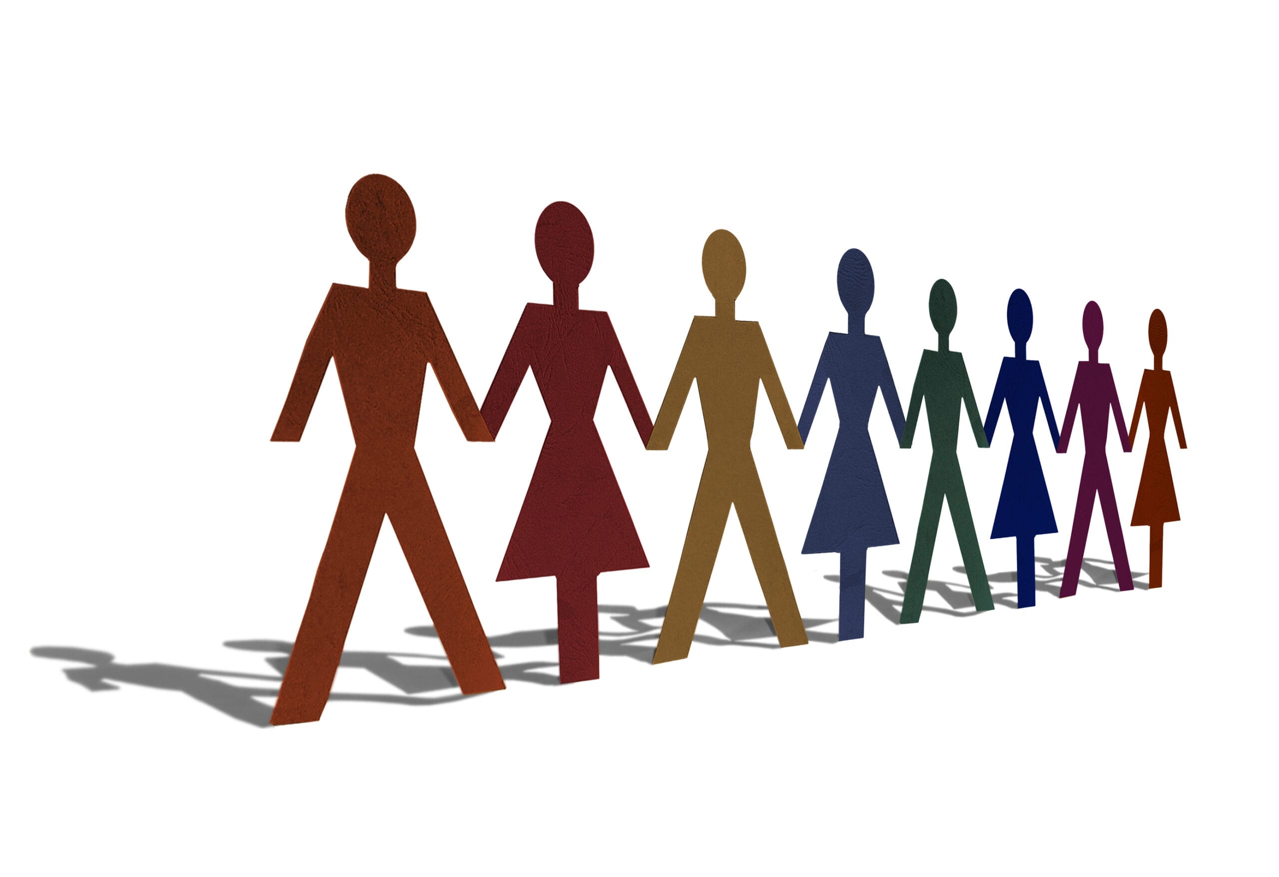 Eine Reihe von ausgeschnittenen Papierfiguren in verschiedenen Farben, die sich an den Händen halten, symbolisierend Vielfalt und Gemeinschaft. Die Figuren stehen in einer Linie und ihre Schatten fallen auf den Untergrund, was einen dreidimensionalen Effekt erzeugt.
